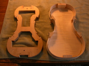 Frame and outer shell, during construction, of a stringed instrument, perhaps a viola.