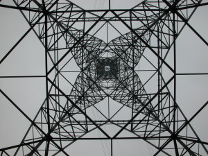 Huge powerline tower seen from center bottom for geometric effect.
